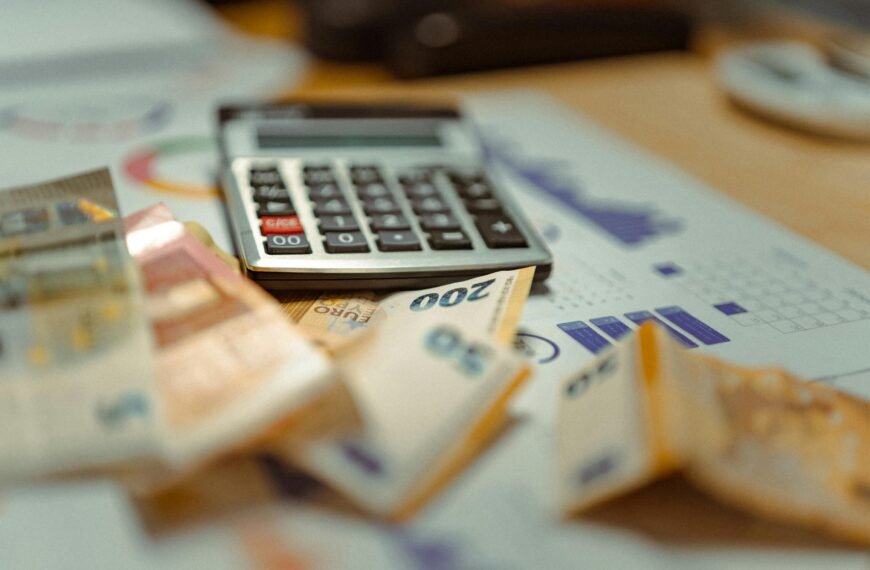 INICIO Euro banknotes and calculator on financial documents, focusing on business budget planning.